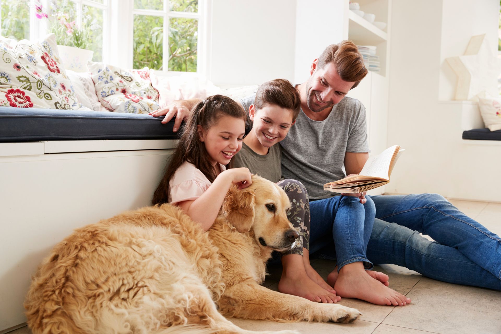 Family spending time with a dog at home