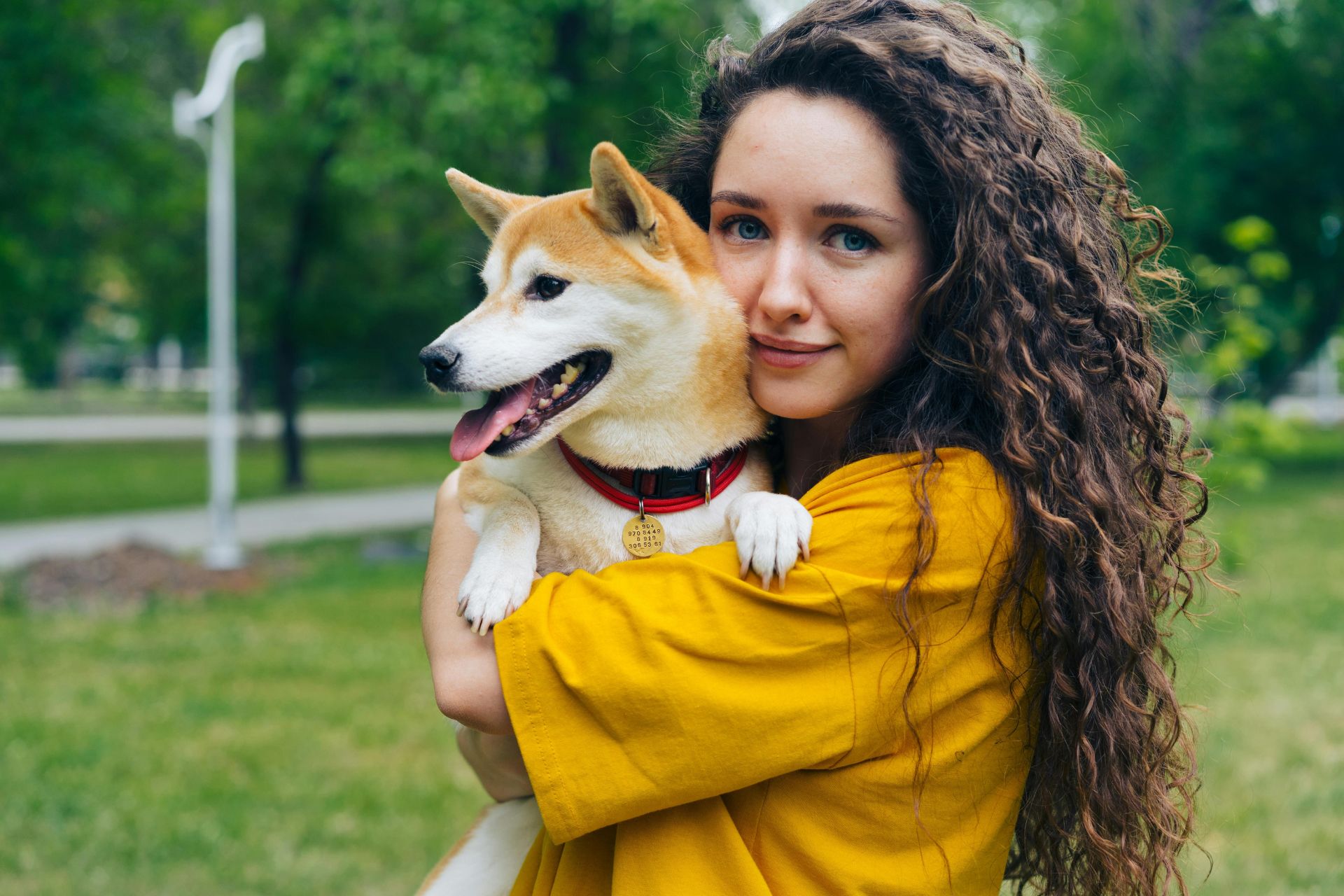 Woman hugging a happy dog outdoors